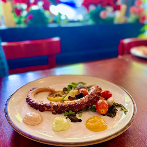 Grilled octopus with cherry tomatoes and dipping sauces
